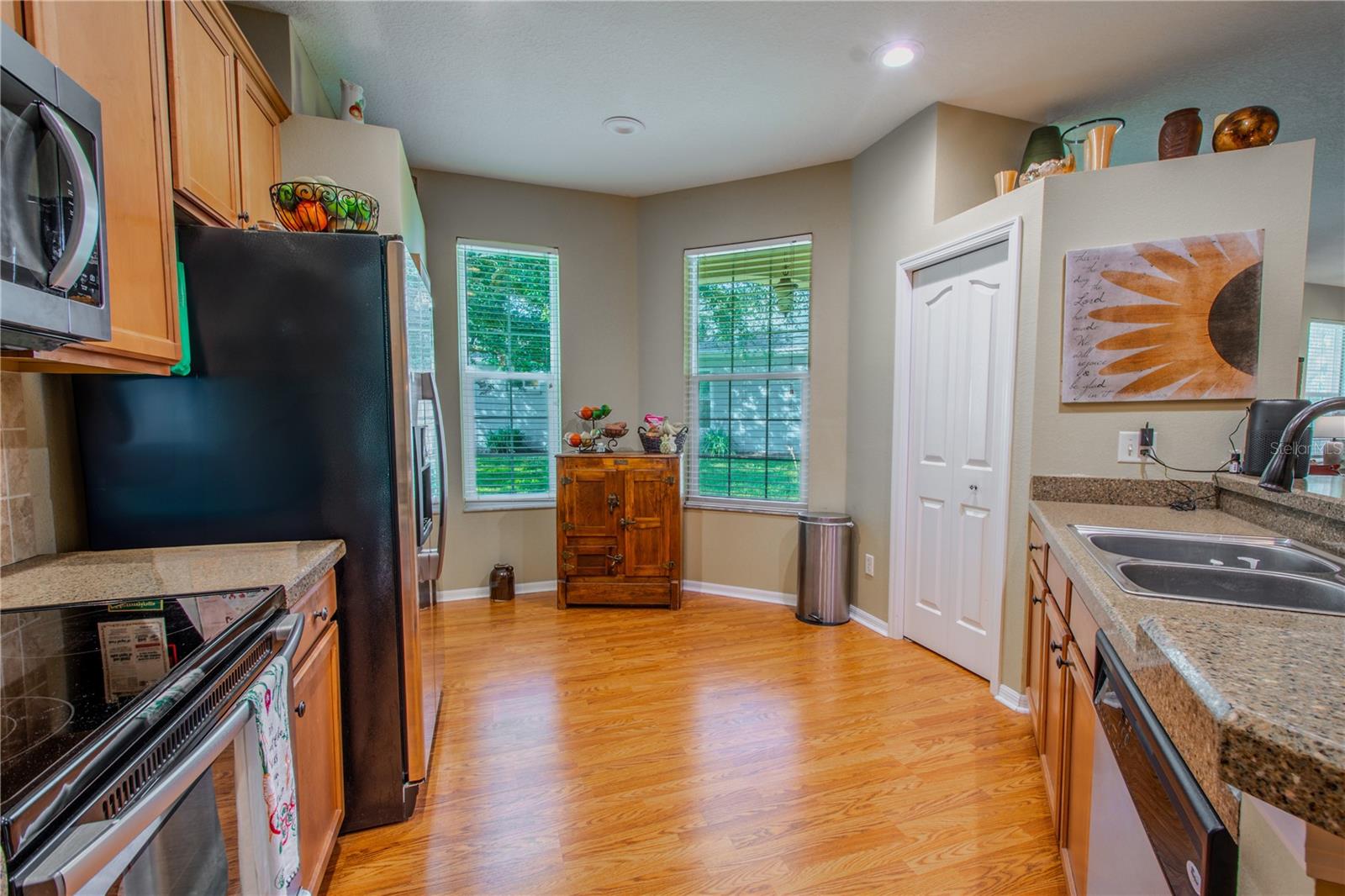 The kitchen features Reconstituted granite countertops, a suite of stainless steel appliances and a closet pantry.