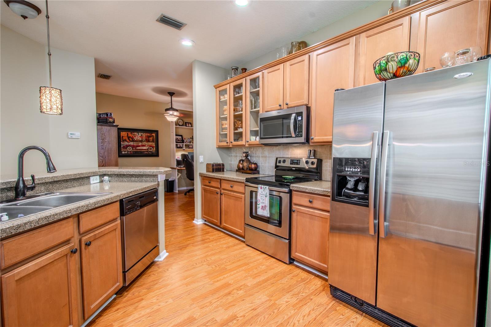 The kitchen features a French door refrigerator with icemaker and water dispenser.