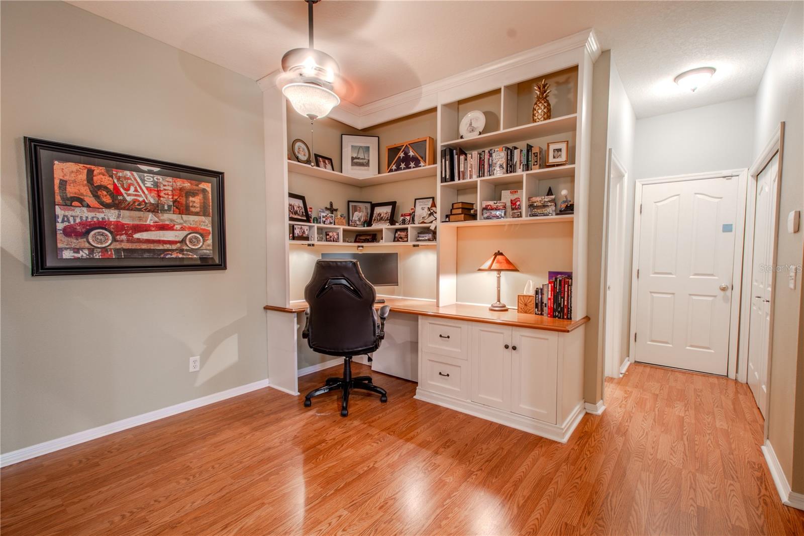 The office with buil-in desk and shelving is just off the kitchen. This room could also be used as a dining room or den.