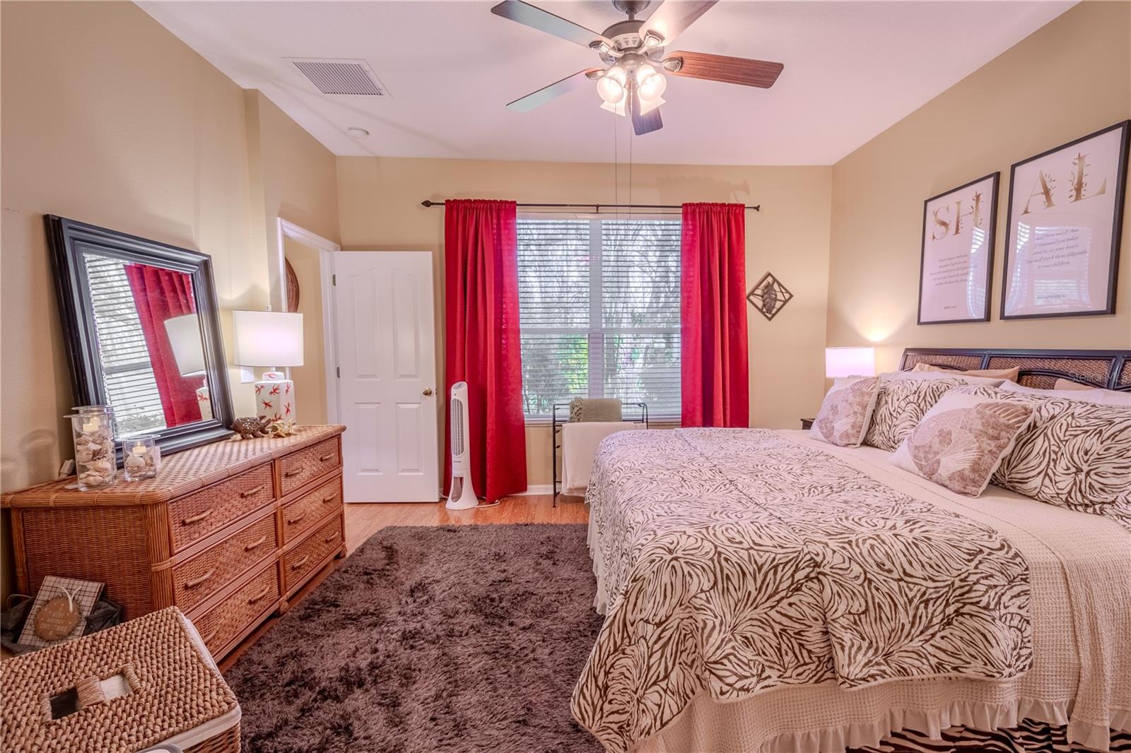 The primary bedroom features a picture window that frames the view of the private backyard.