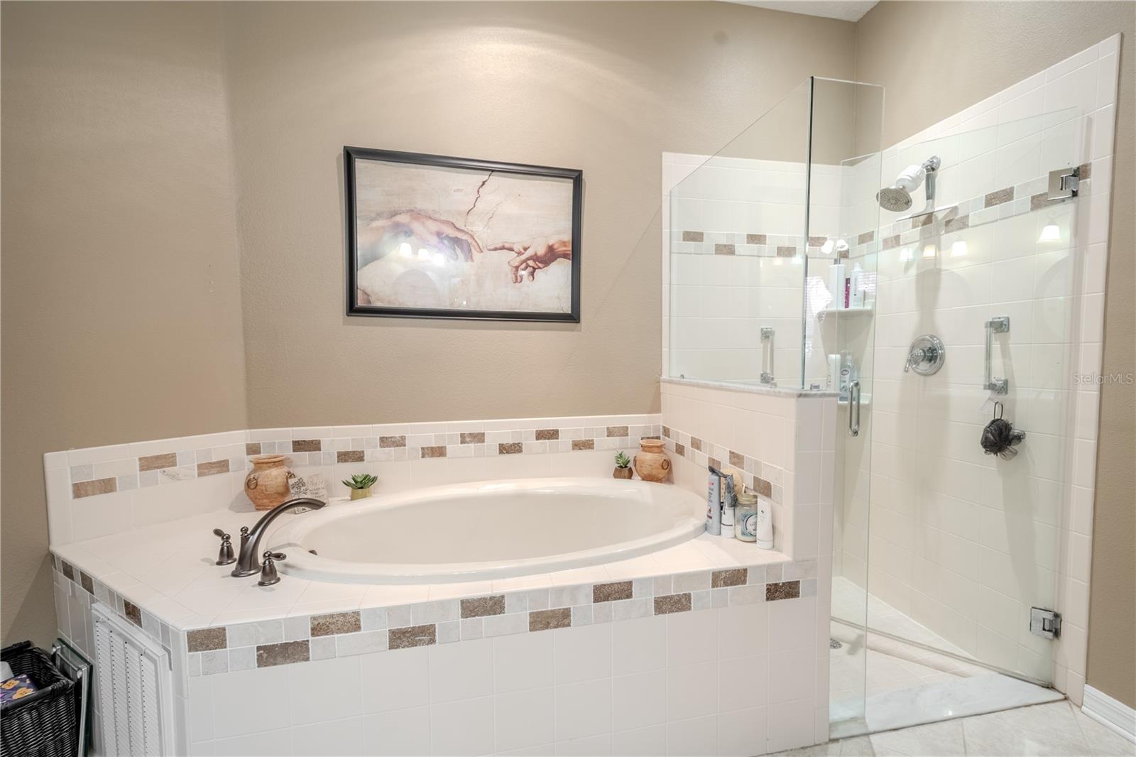 Primary bath garden tub with separate shower.