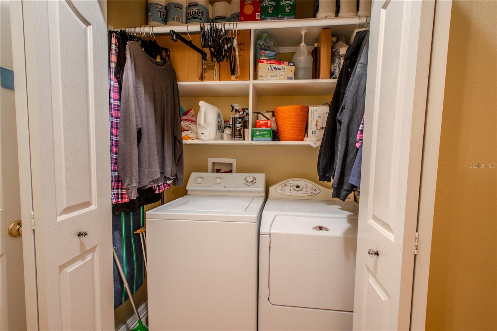 A convenient launry closet with built-in shelving.