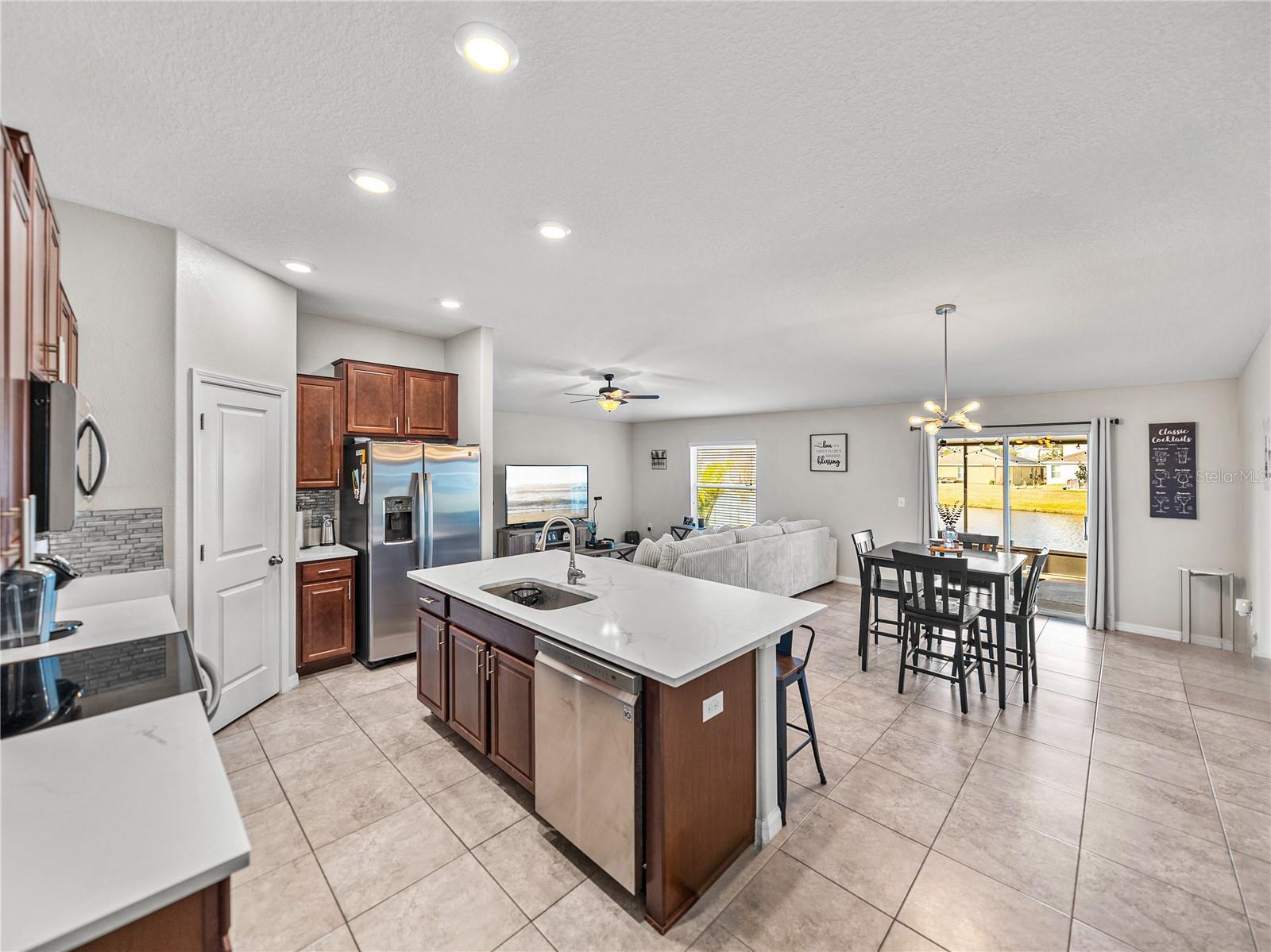 Updated kitchen with newer stainless appliances, quartz countertops, and backsplash~