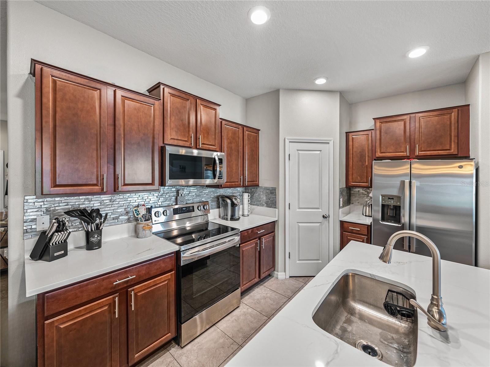 Recessed lighting and oversized walk-in pantry~