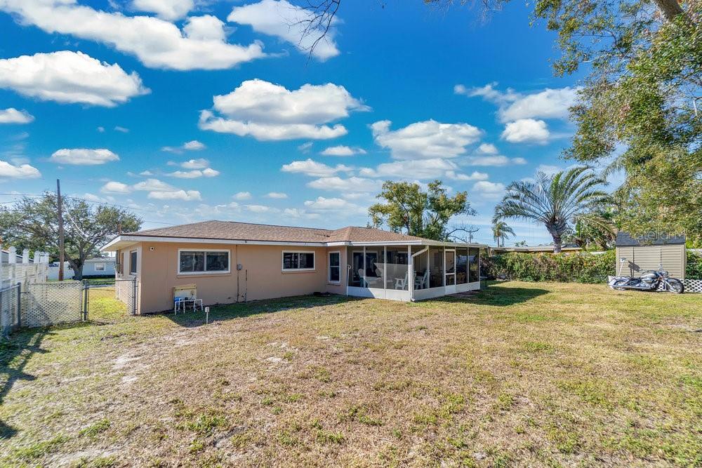 Large fenced yard with storage shed