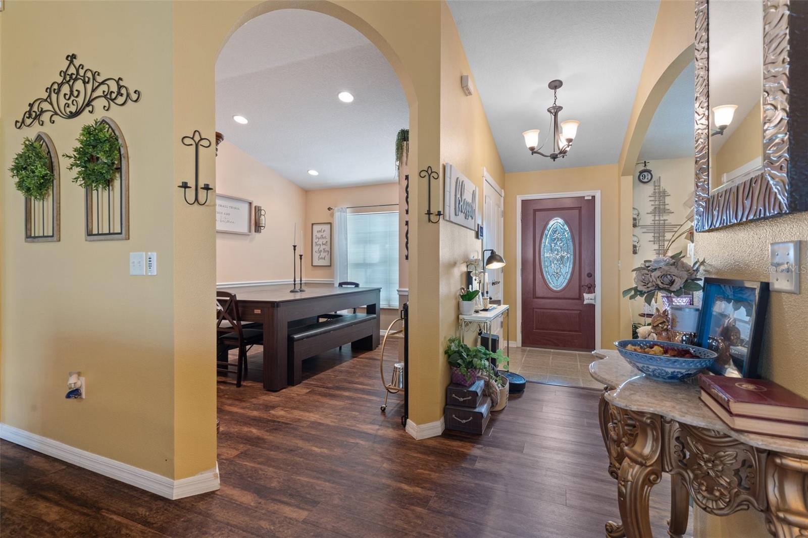 Looking into the beautiful arched doorway into the  formal dining room