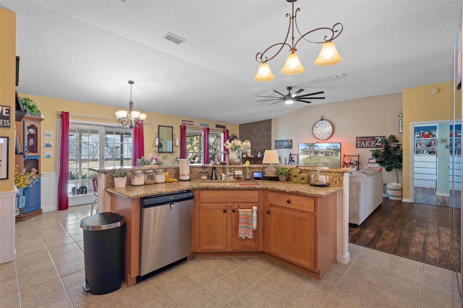 The island in the kitchen has a dishwasher, gorgeous sink and Granite Breakfast Bar beautiful sink