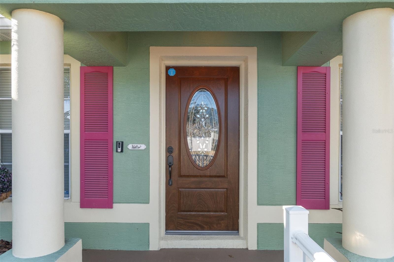 Notice the elegant pillars and gorgeous front door