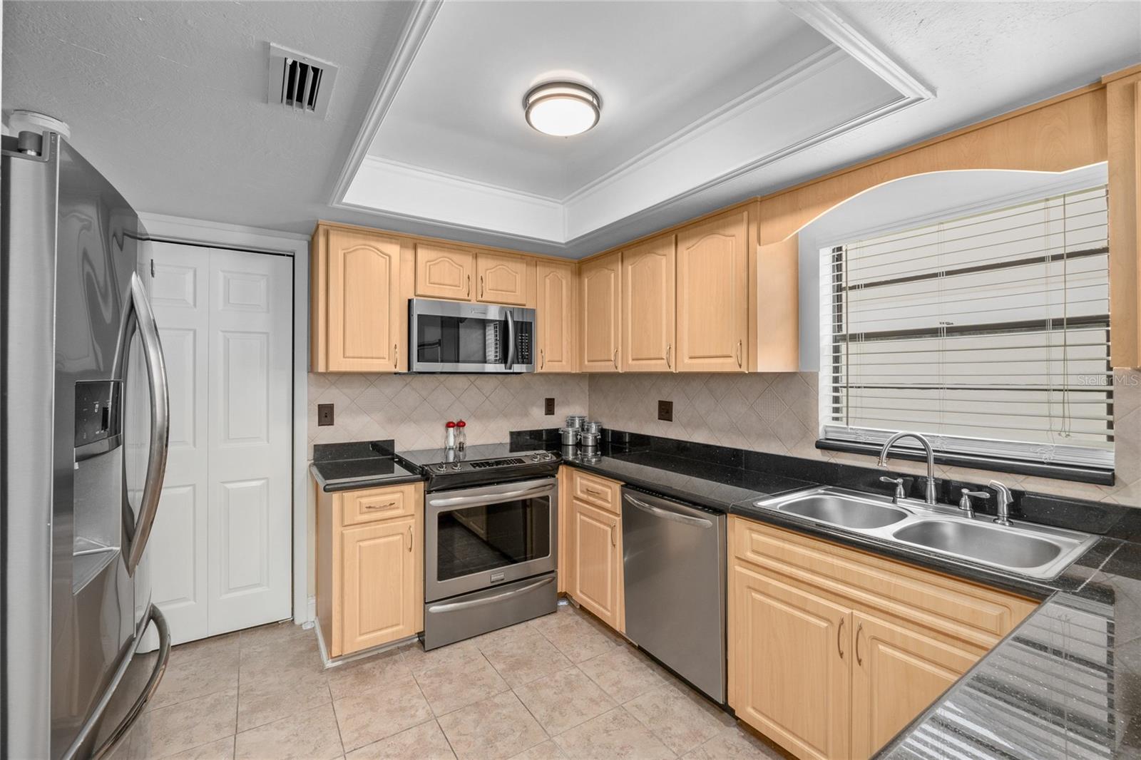 Primary Bathroom is updated with dual sinks, stylish storage space and a tiled shower