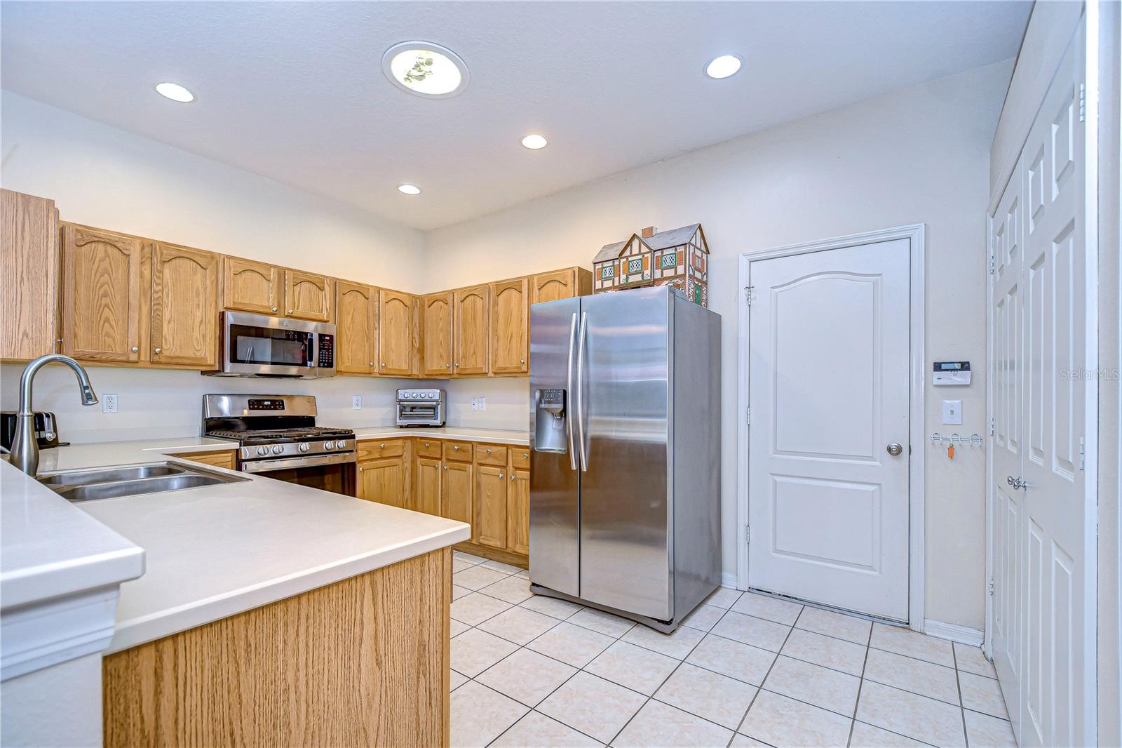 Entrance to 2-car garage to the right of refrigerator