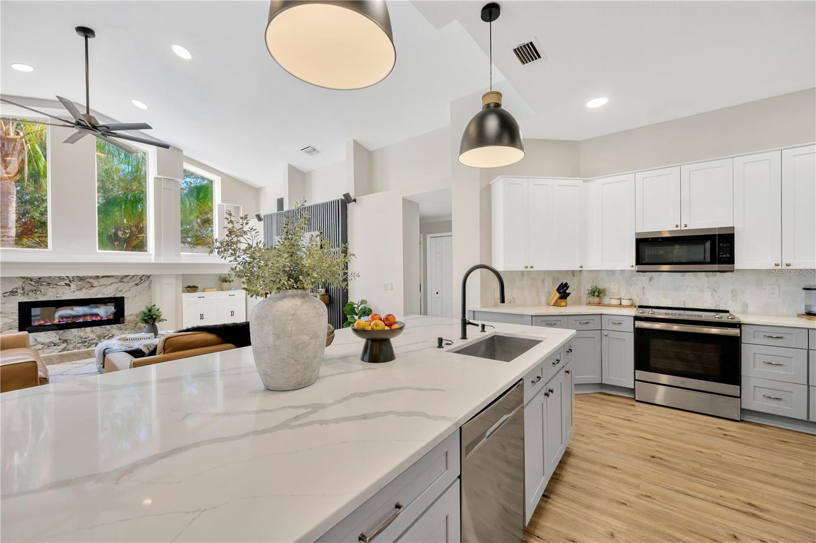 This updated kitchen is a Pinterest-worthy chef’s dream and showcases a large island with a built-in sink and sleek quartz countertops.