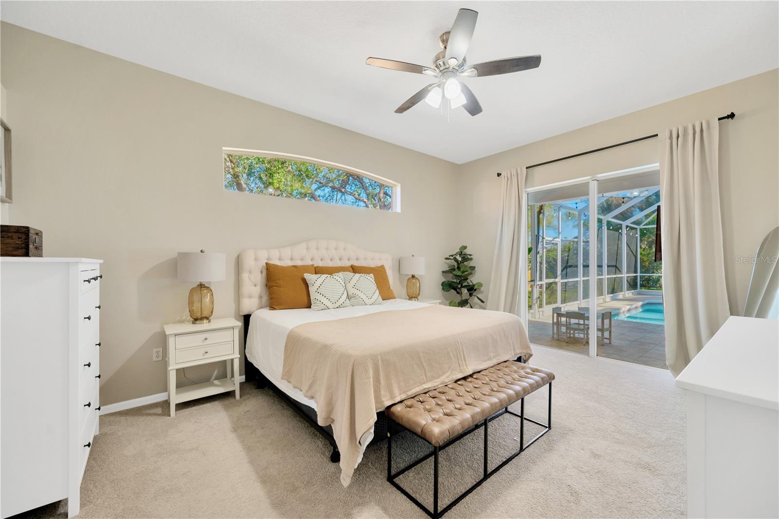 The primary suite serves as a serene retreat and has easy access to the pool area.