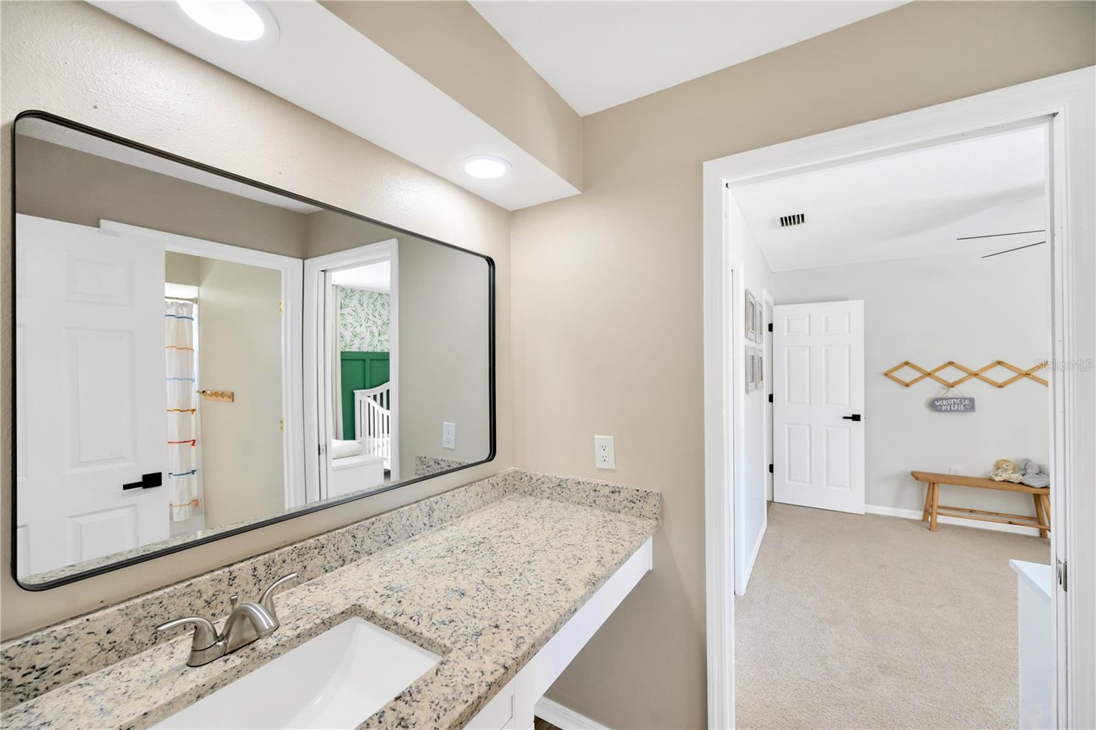 The "Jack-n-Jill" bathroom shared by Bedroom 2 & 3 has dual vanities with updated sinks and fixtures.