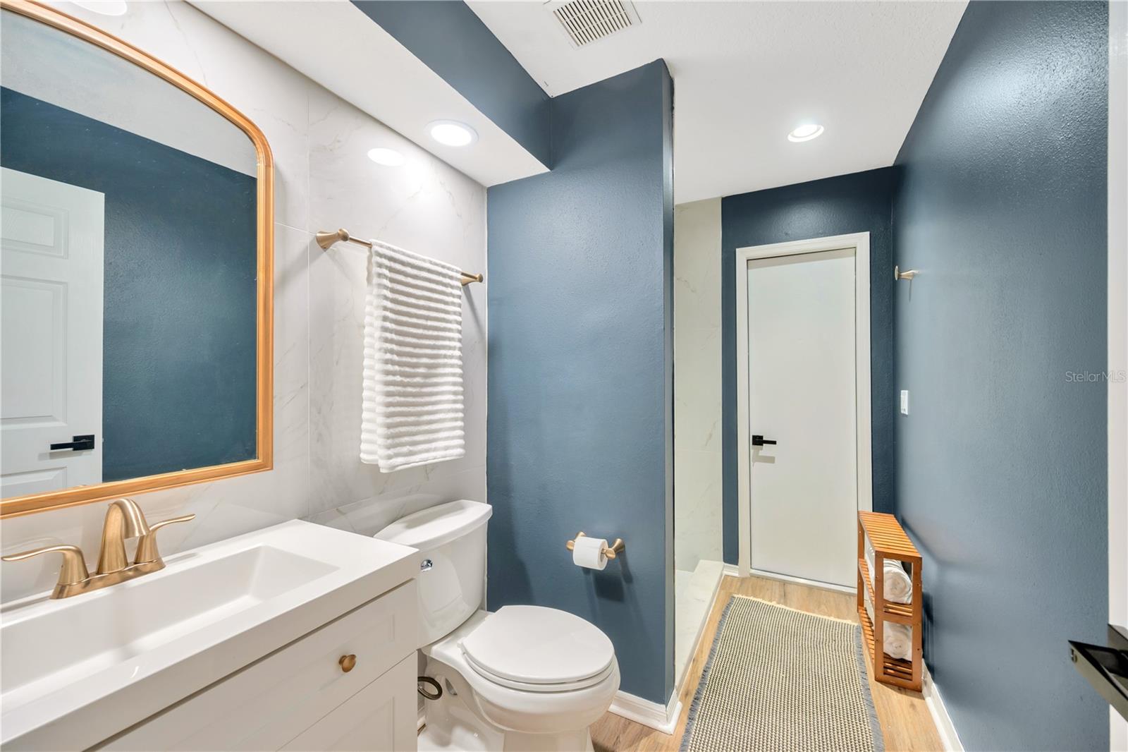 Bathroom #3 has recently been updated with newer vanity, sink & fixtures and a fully tiled shower and sink wall.  The door next to the shower provides direct access outside to a walkway leading to the pool for guests to utilize.