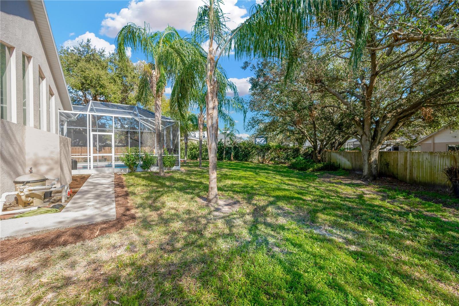 Walkway from pool bathroom to pool area inside screened lanai.