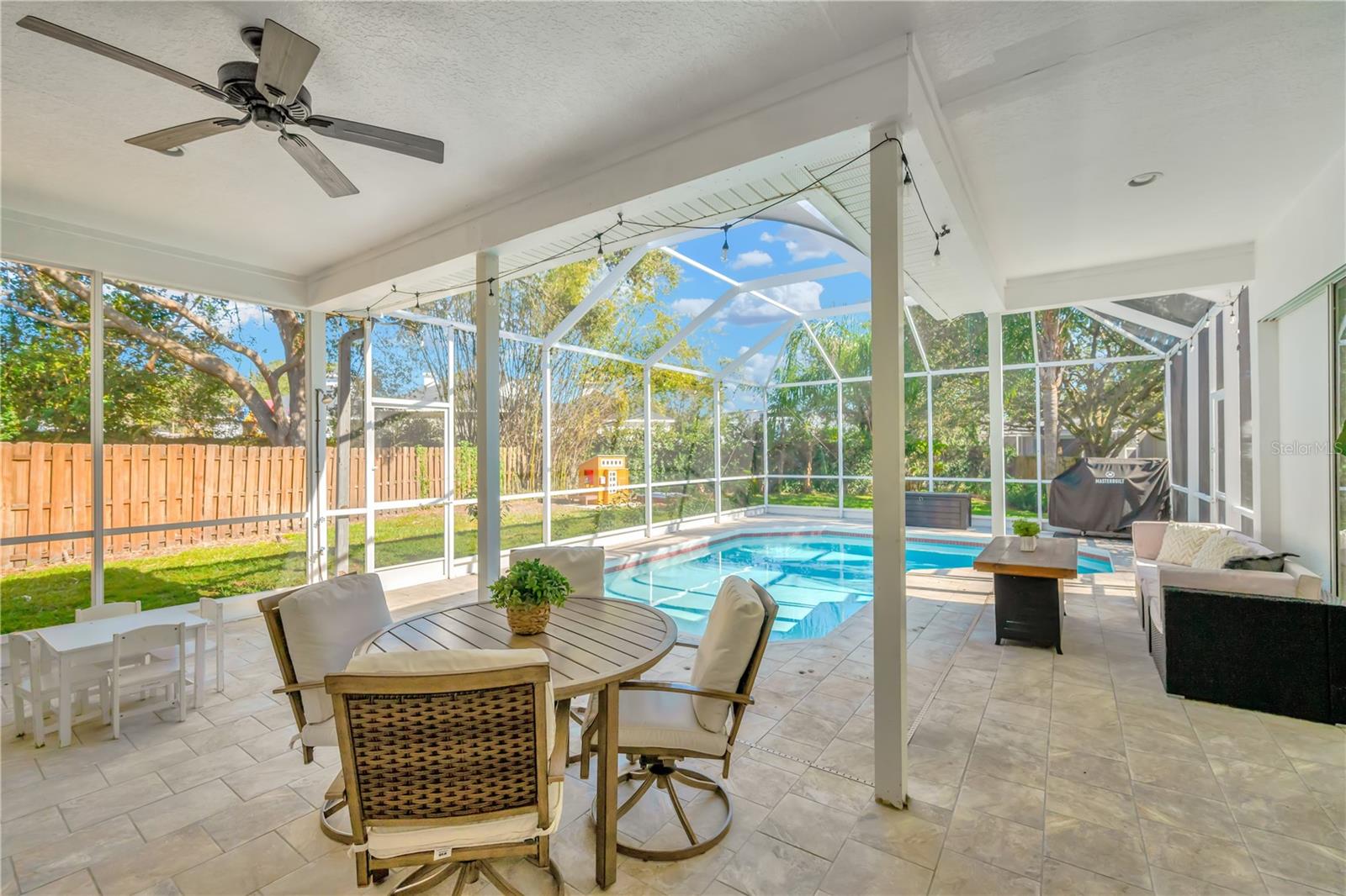 Hosting backyard BBQs and enjoying unforgettable moments with family and friends is easy with this covered patio and large yard.