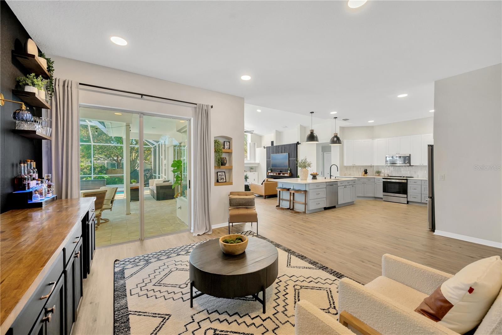 You'll be immediately captivated by the beautiful pool view and the spacious open floor plan with many stylish upgrades, featuring brand new luxury vinyl plank flooring and fresh interior paint throughout.