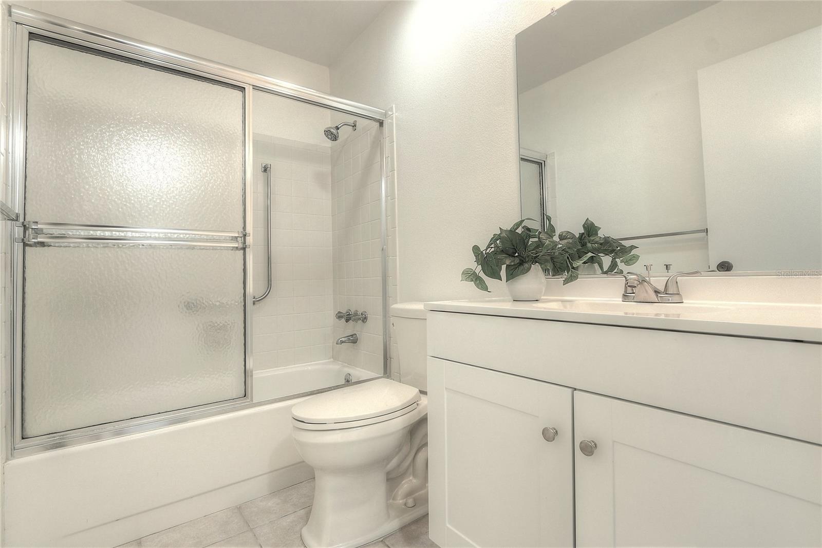 2nd bathroom with newer sink and vanity.