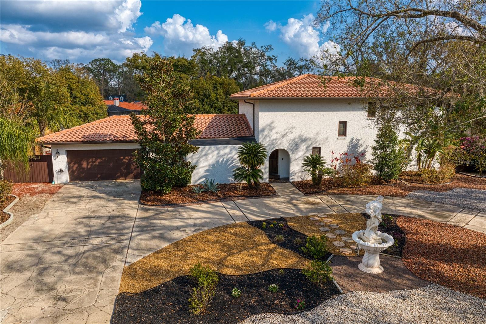 Front exterior garage entry with able gated fence entry to backyard .