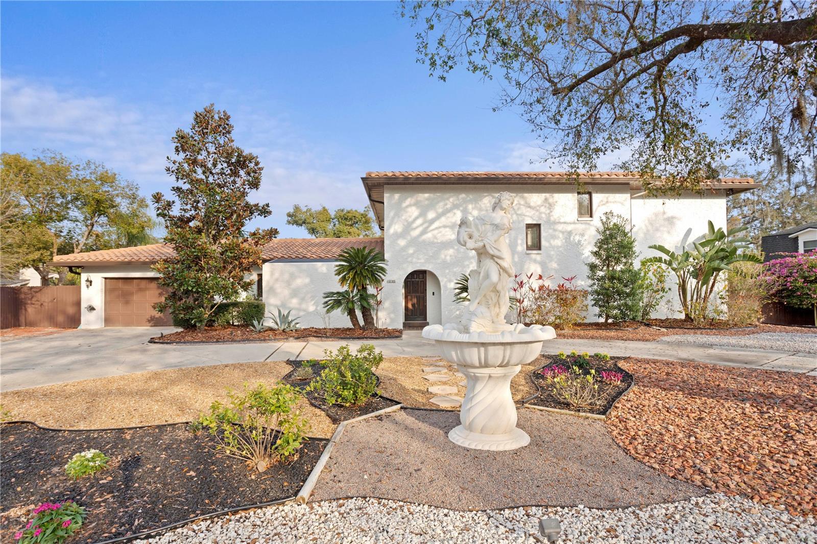 Front exterior with custom goddess fountain with light to enhance this home’s regal ambiance