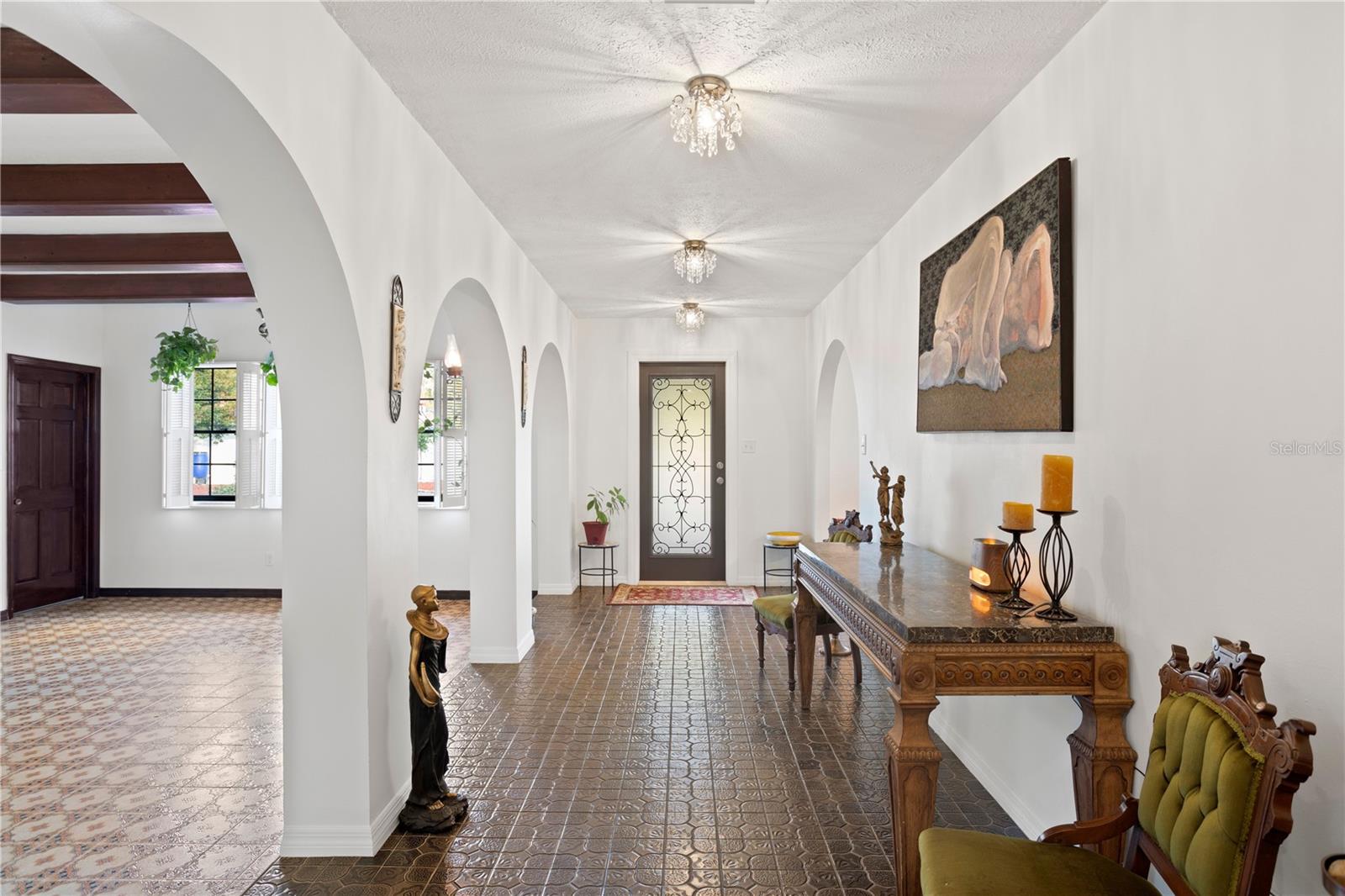 Front entry foyer with glass door to back yard .