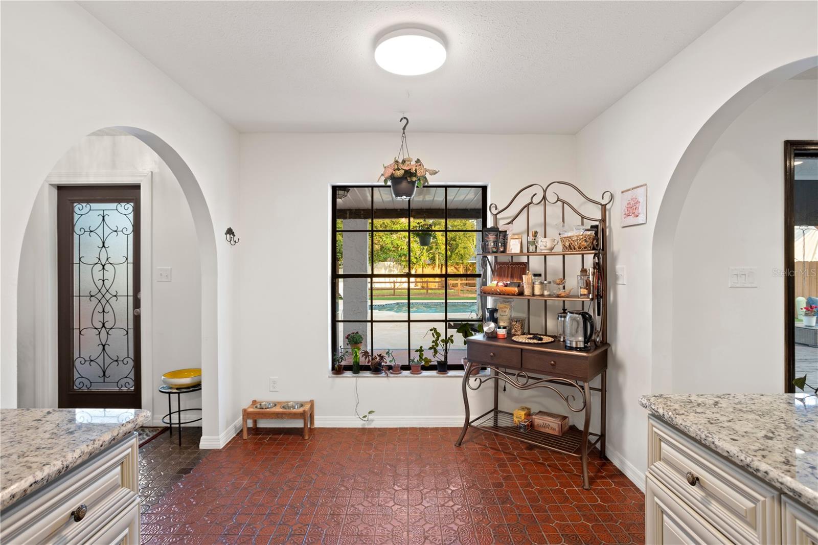 Off foyer entry eating space in kitchen with door and window with access  to exterior covered patio