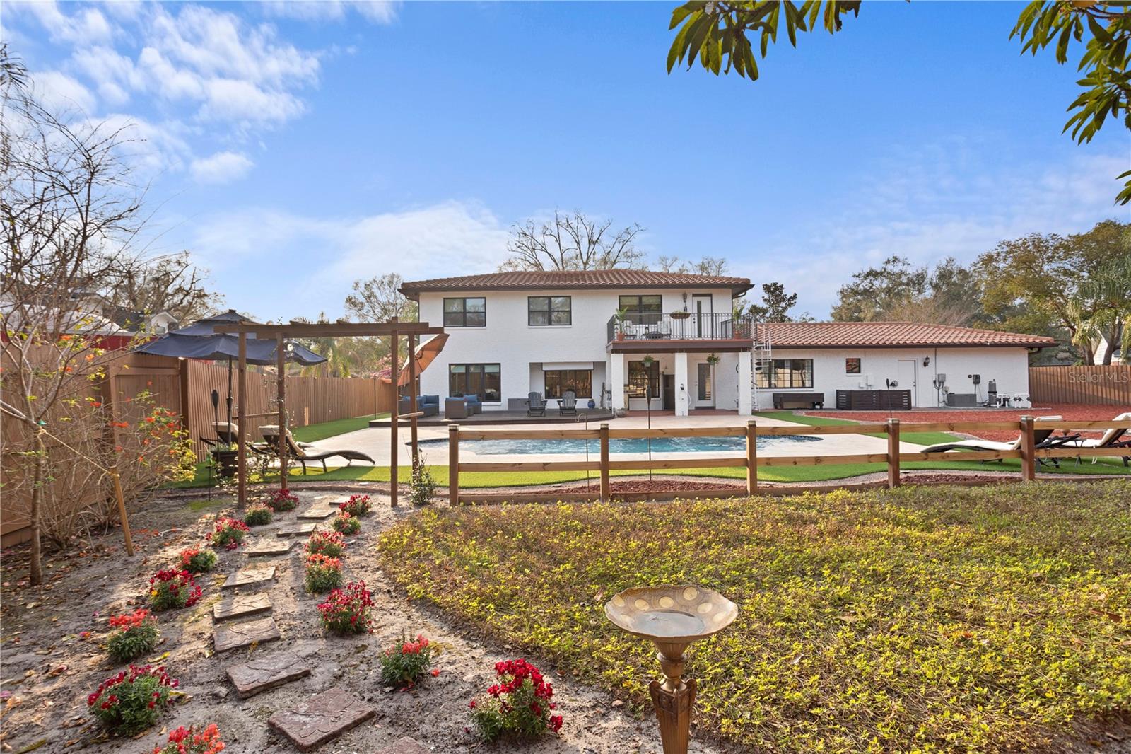 Butterfly garden trial to backyard pool deck