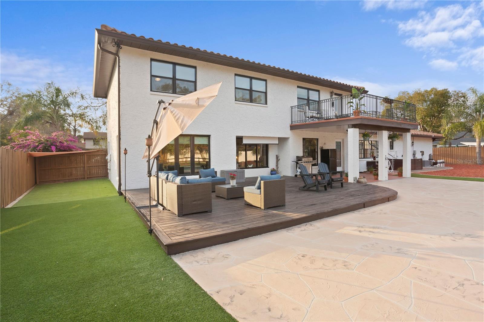 Exterior backyard side dog run, sun deck patio, to stamped concrete pool deck