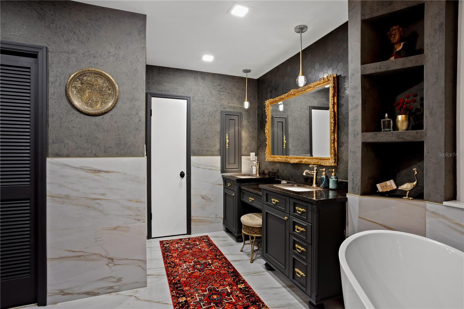 Master bath with Marble floors and walls with walk in closet