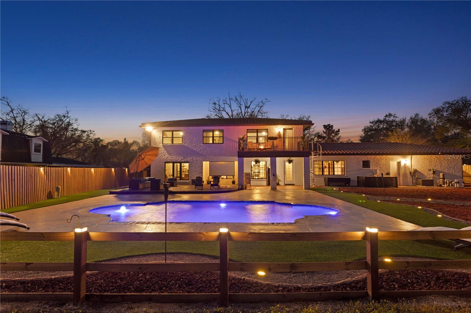 Twilight night view of custom lit Grecian pool , patio, terrace