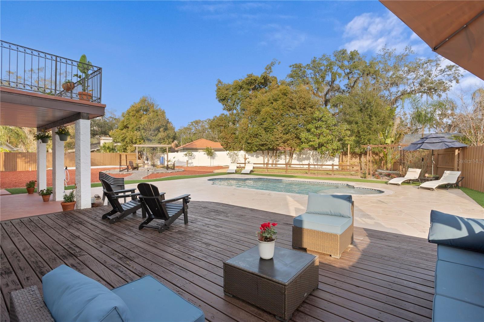 Exterior sun-deck entertaining space overlooking pool