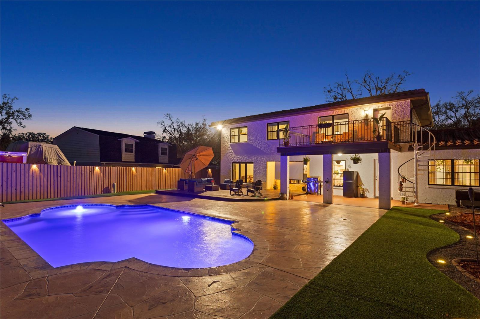 Back exterior entry to dining room off kitchen , sun deck with tv projection entertaining space , covered patio and staircase to master en-suite