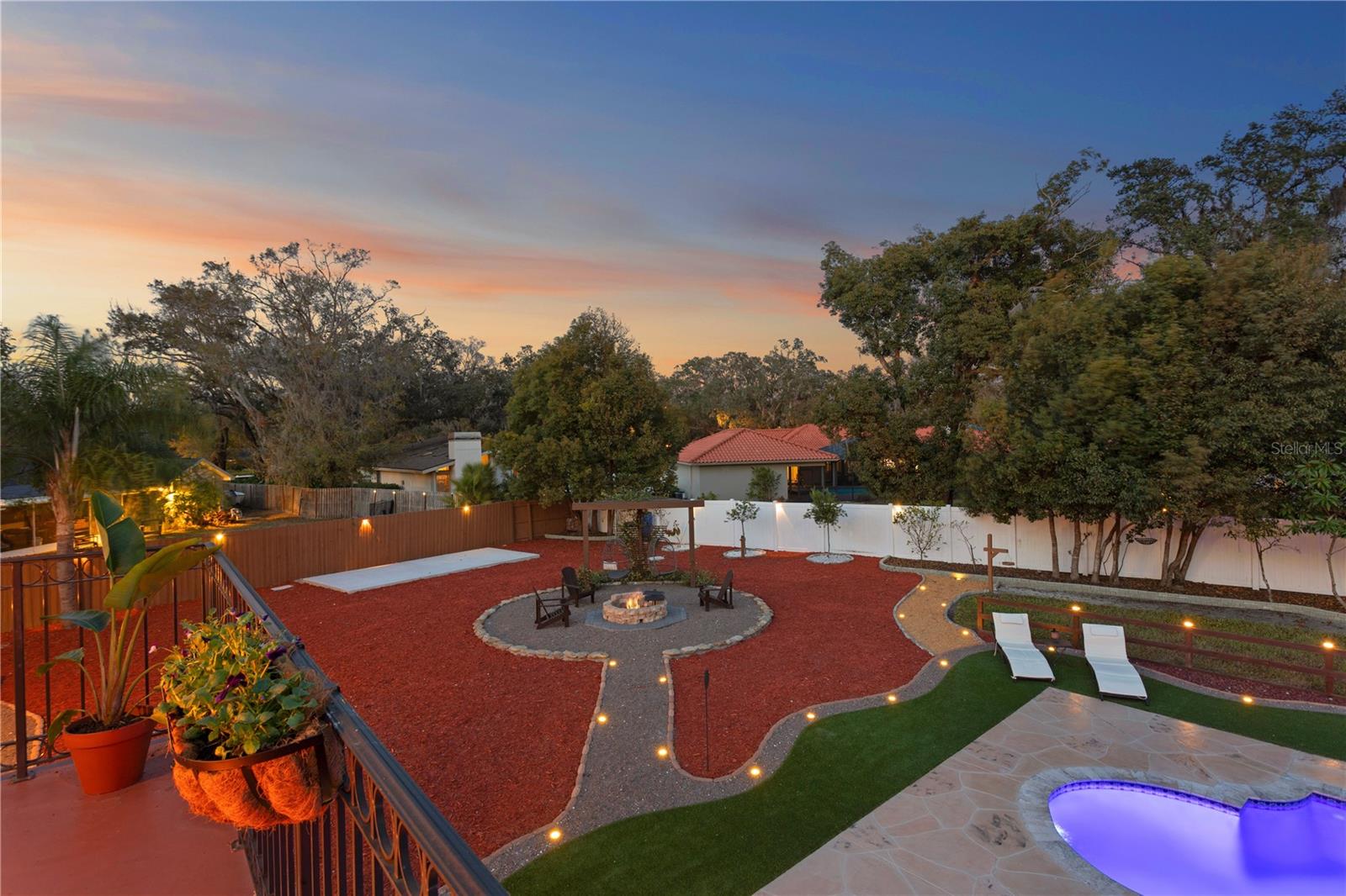 Backyard view from master bedroom open 2nd floor terrace show casing fire pit lounge area, fully gated backyard and extra space to store boat , shed or build to suit pool house cabana.