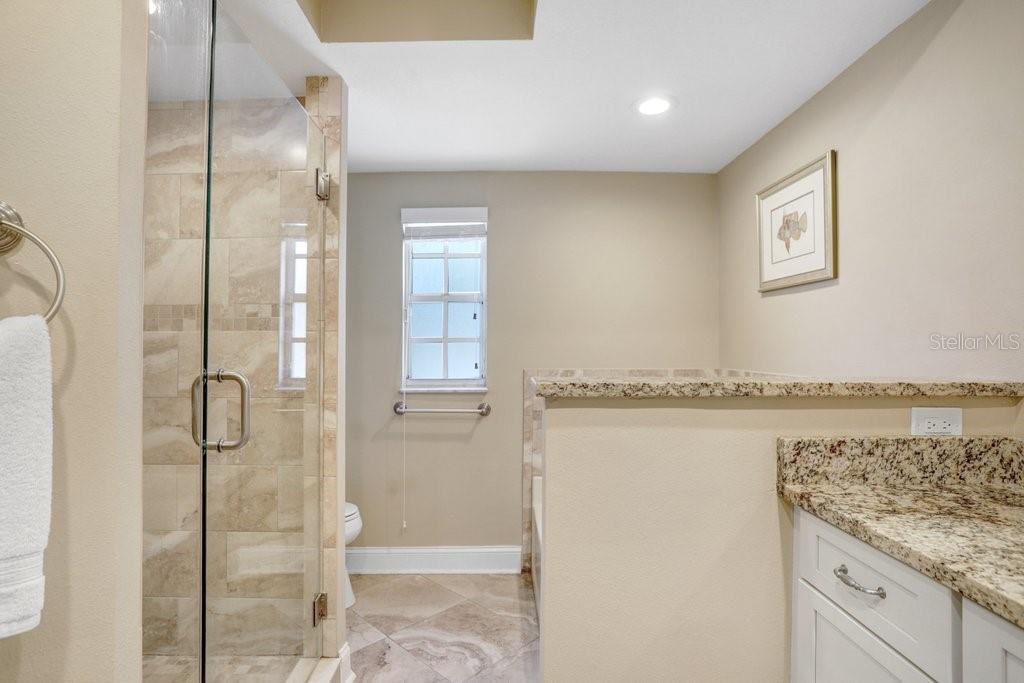 Completely renovated bathroom with new tile, cabinets and granite countertops