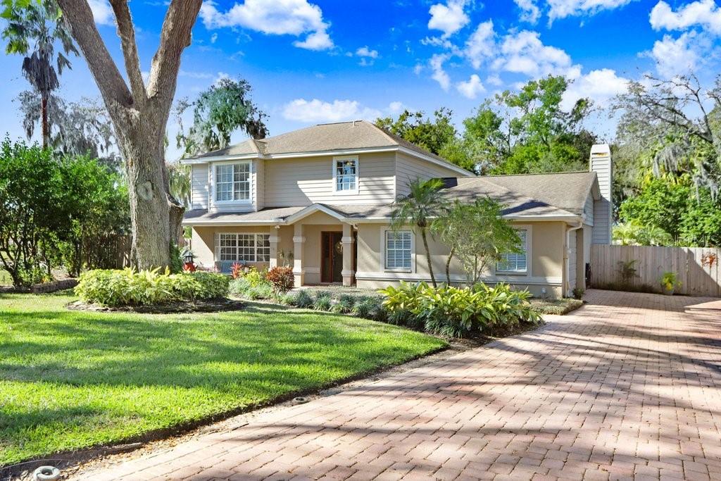 Front View of home with beautiful paves and the side garage entrance