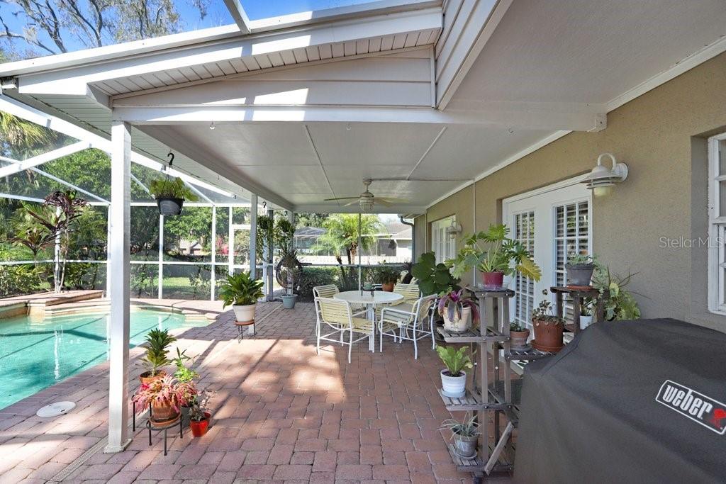 Lanai with beautiful pavers, view to back yard and pool