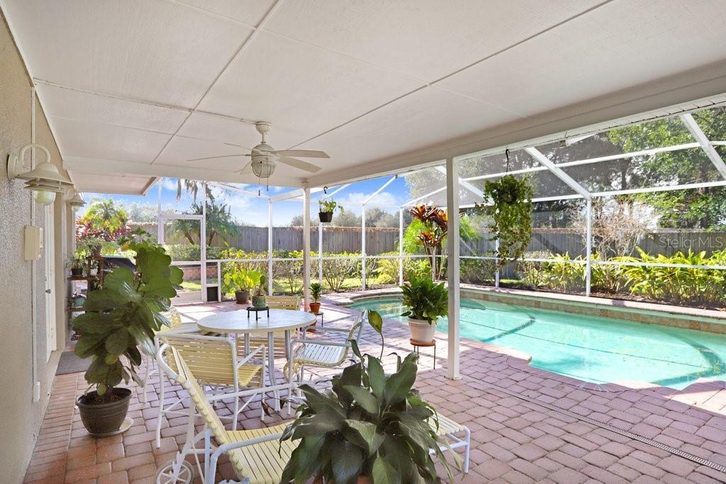 Lanai with beautiful pavers, view to back yard and pool