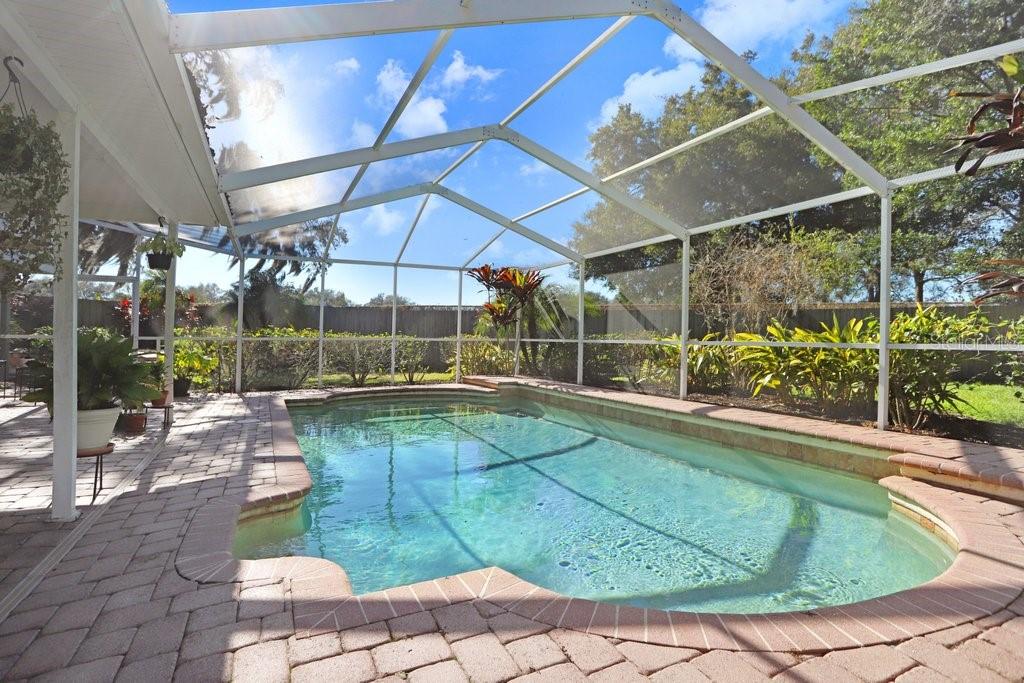 Lanai with beautiful pavers, view to back yard and pool