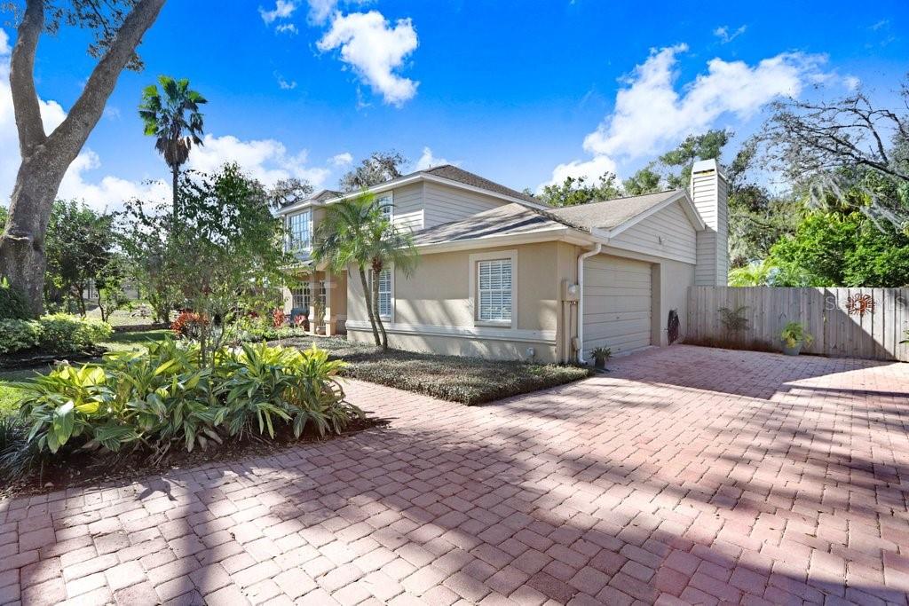 Front View of home with beautiful paves and the side garage entrance