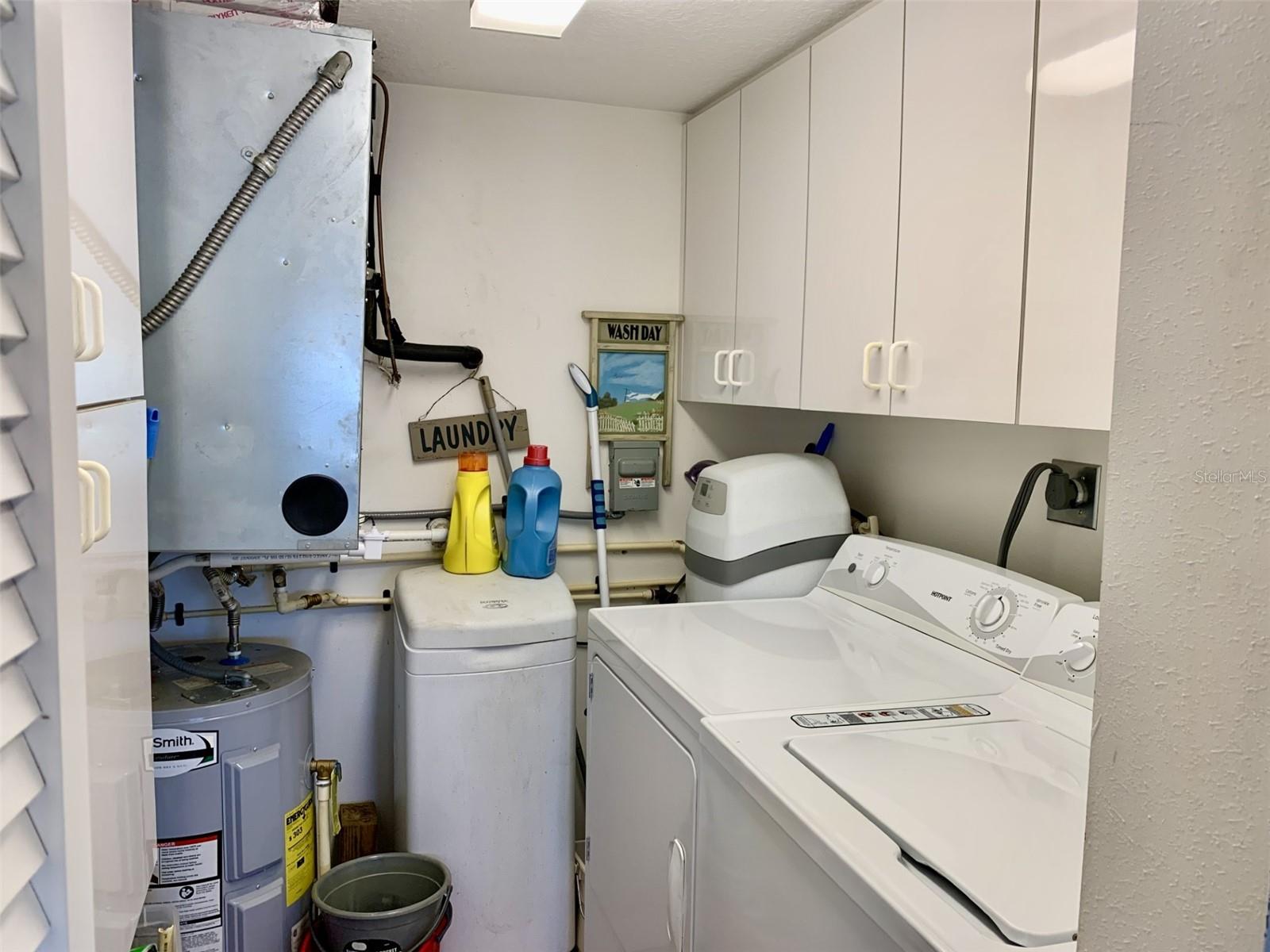 Laundry area has additional cabinets that double as a pantry