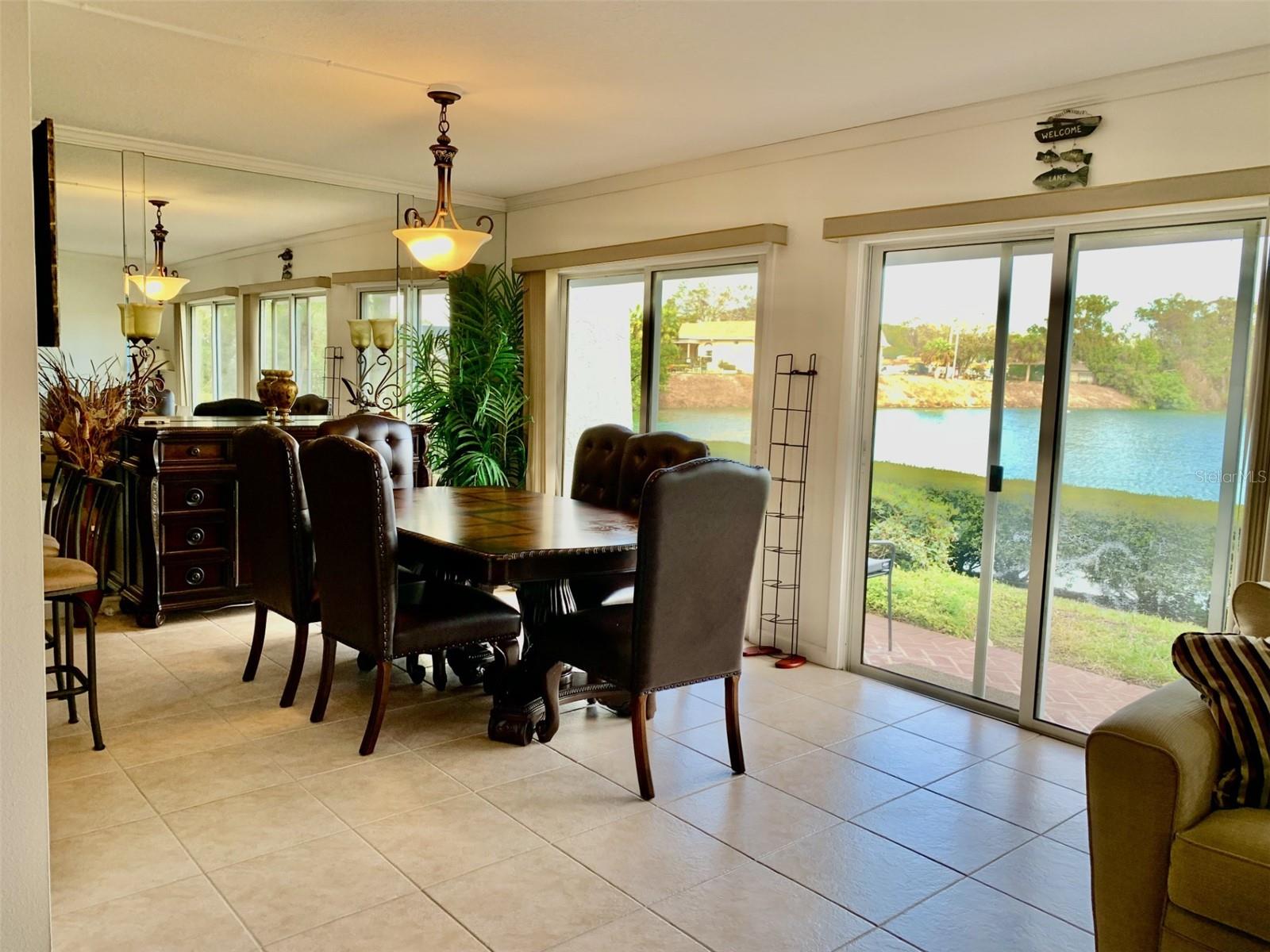 Open dining room has view of pond, kitchen and great room