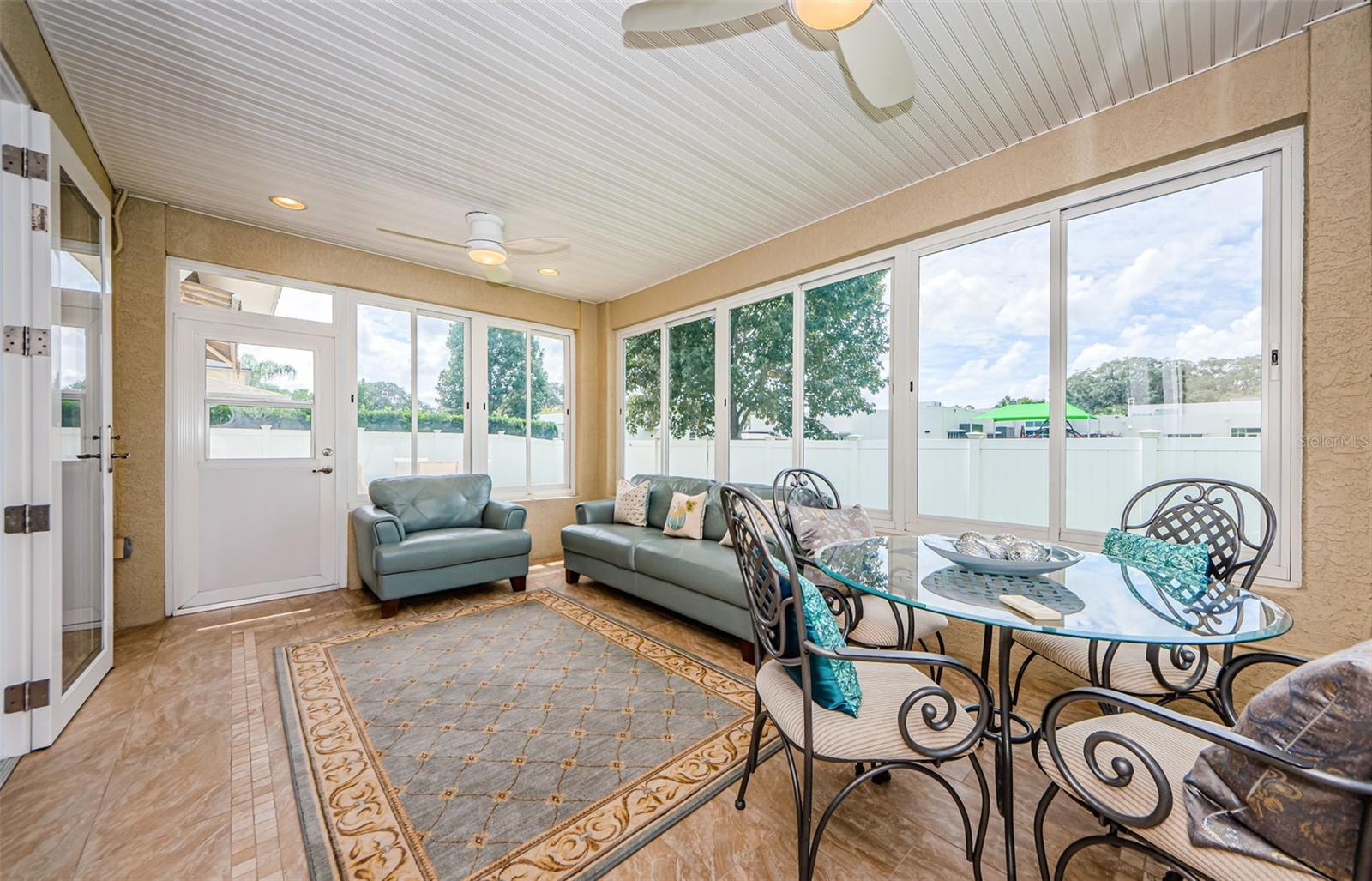 Sunroom Featuring Acrylic Windows & Two Ceiling Fans