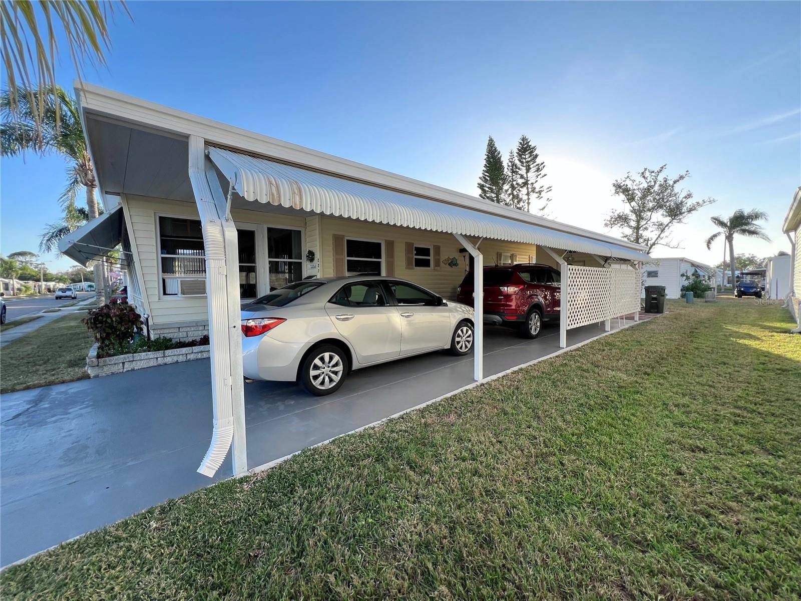 North carport side with a long driveway.