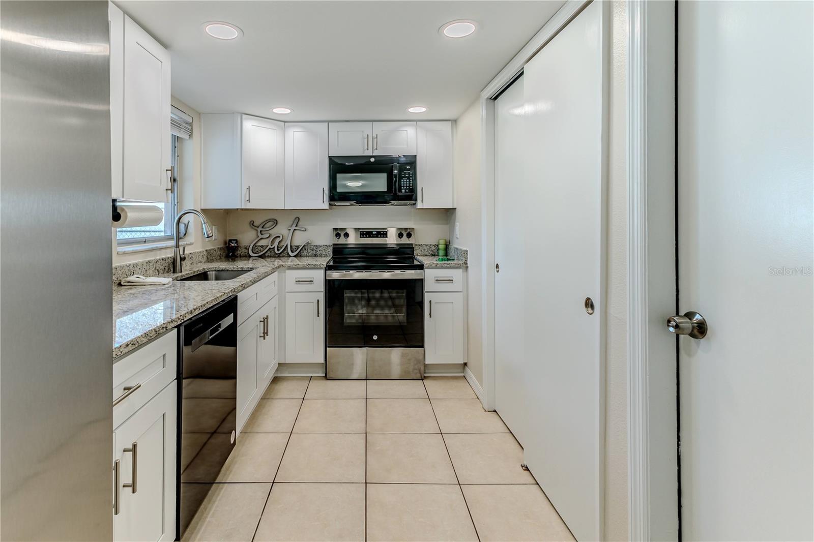 Pantry with sliding doors in this amazing kitchen, so much room!