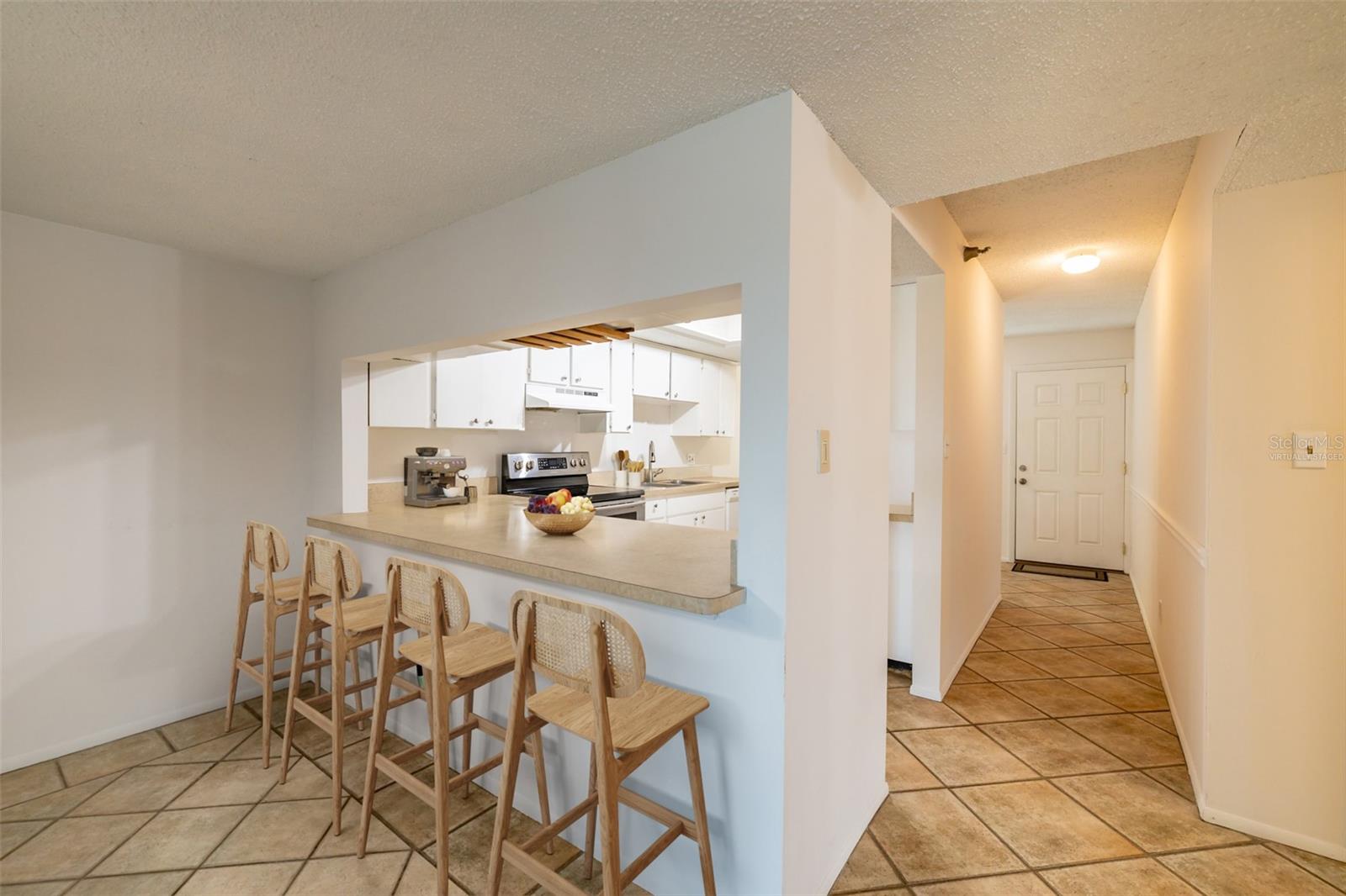 Virtually Staged - Kitchen bar provides a casual dining option, great for quick meals or socializing while cooking.