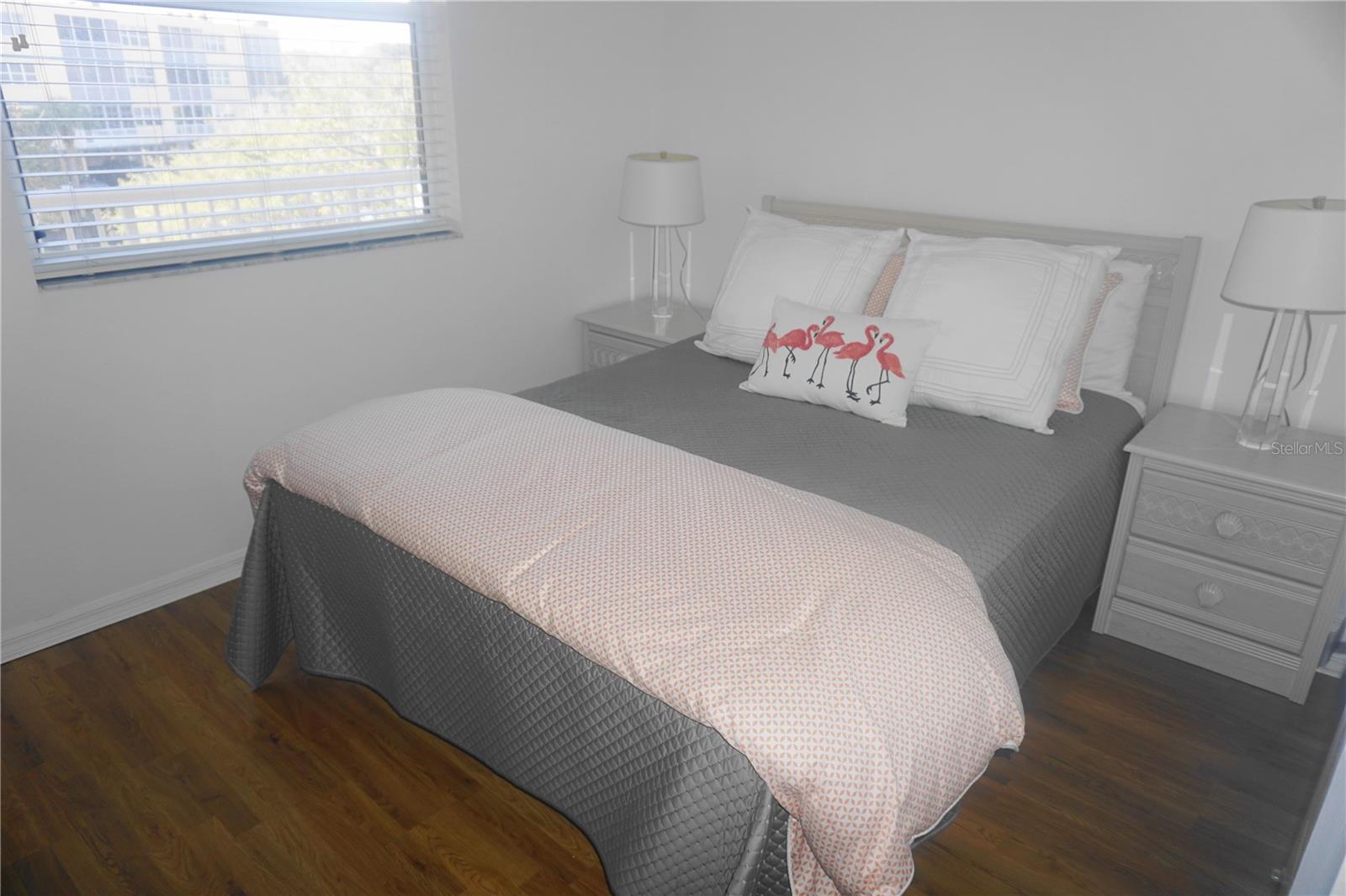 The bright second bedroom looks out over the clubhouse and pool.