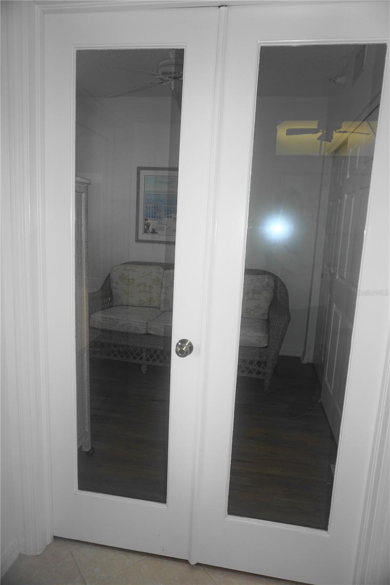 French doors open to a 3rd bedroom, home office or den.