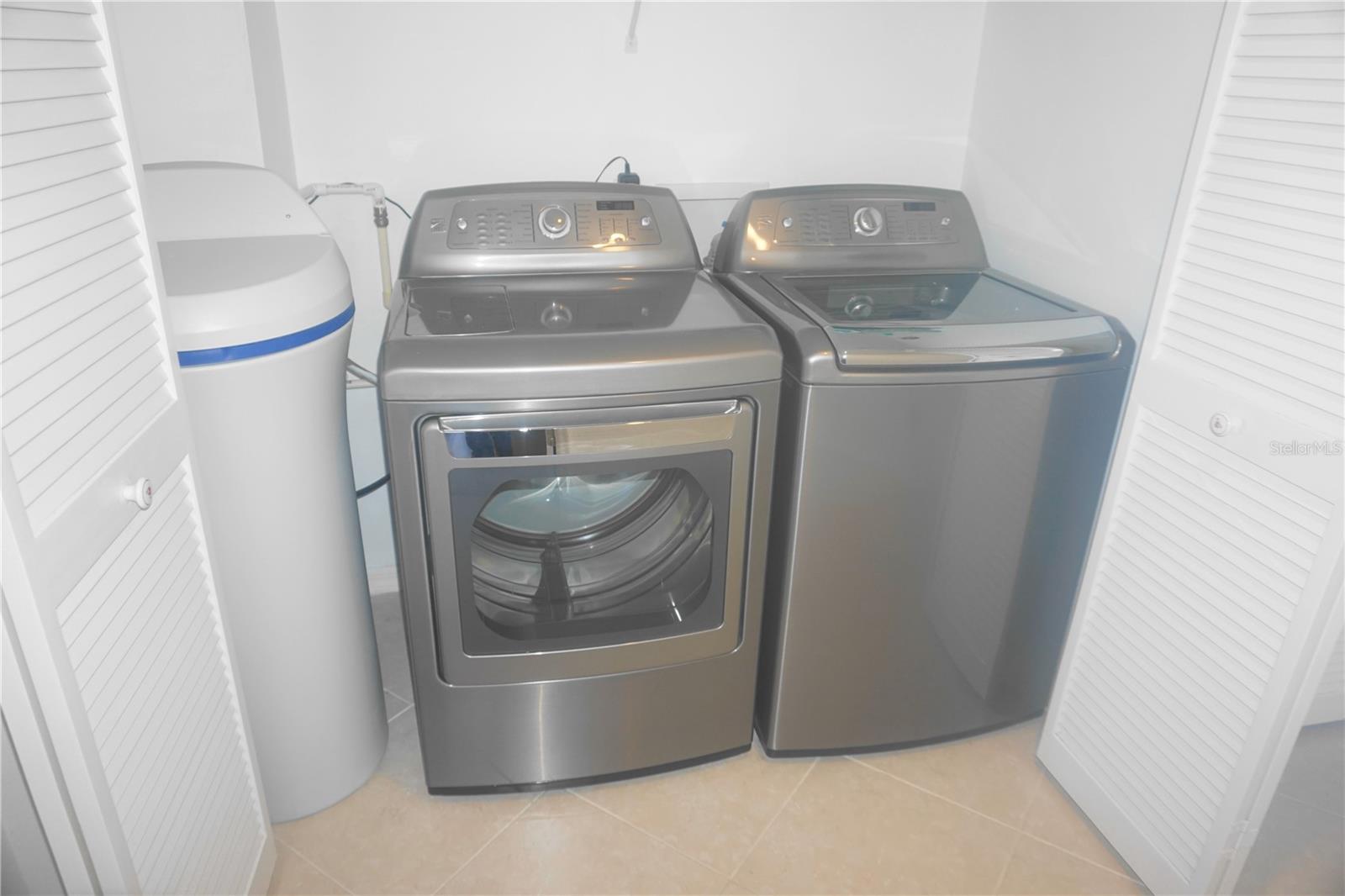 30.The washer & dryer and water softener located in large designated hallway closet