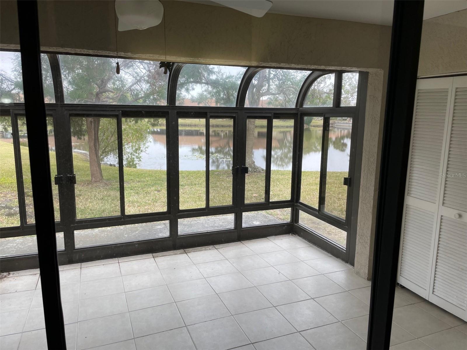 Enclosed patio w/ view to pond