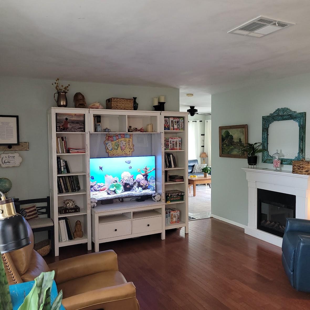 There is room for a large entertainment center and the electric fireplace in this living room.